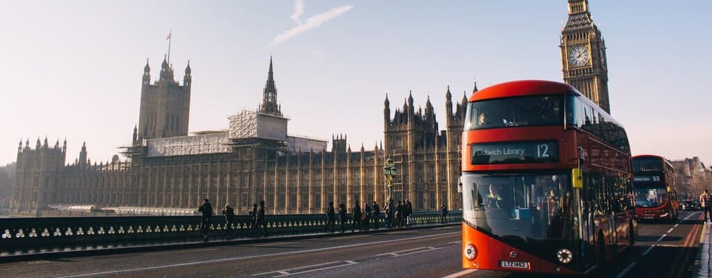 Moving to UK after Brexit - Two Routemaster buses crossing the Westminster bridge.